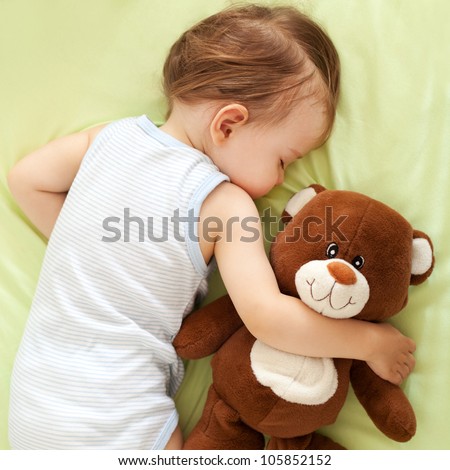 Sweet child sleeping with teddy bear