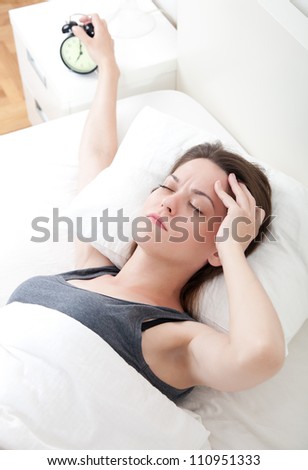 Young woman having trouble with getting up early in the morning