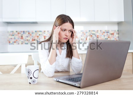 Young woman having trouble with laptop
