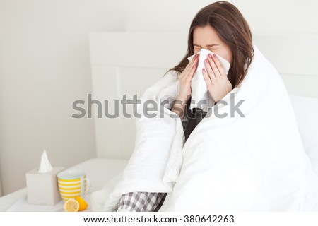 Young woman sick in bed