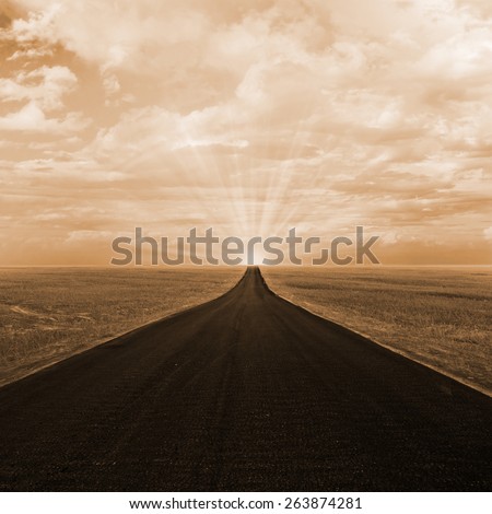 Asphalt road to horizon with sunset sky