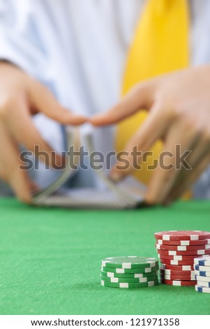 Two hands, shuffling a deck of cards of poker