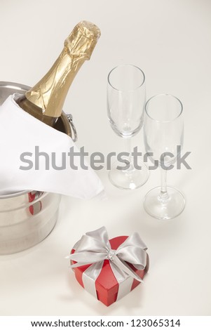 Romantic still life with champagne and beautiful red roses over white