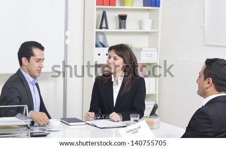 man explaining about her profile to business managers at a job interview