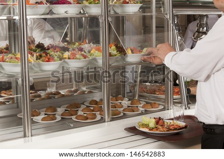 buffet self-service food display human hand take plate
