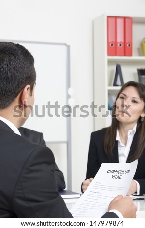 man explaining about his profile to business managers at a job interview