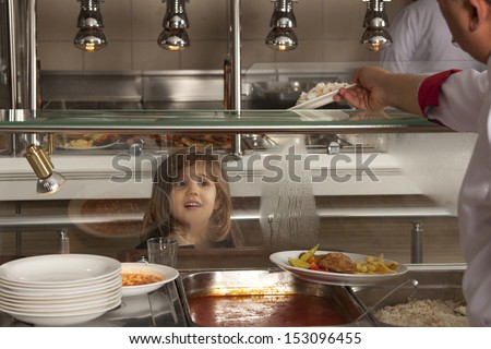 little girl in school cafeteria waiting lunch