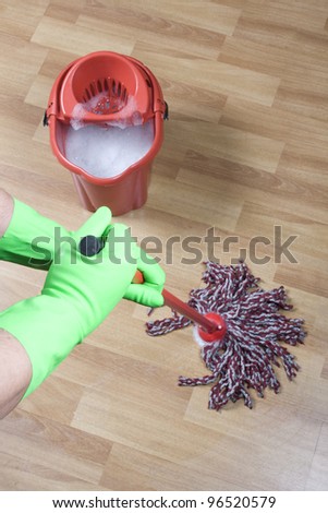 cleaner mopping floor in office