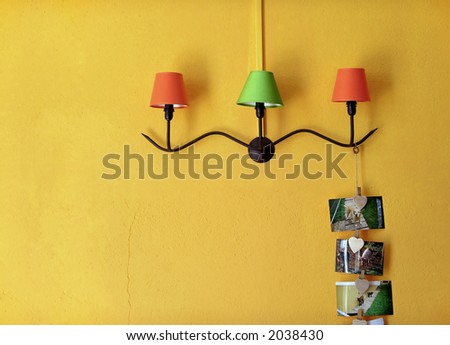 Three decorative lamps with iron holder in yellow wall.