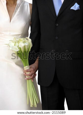 stock photo Groom's black suit and bride's white wedding dress