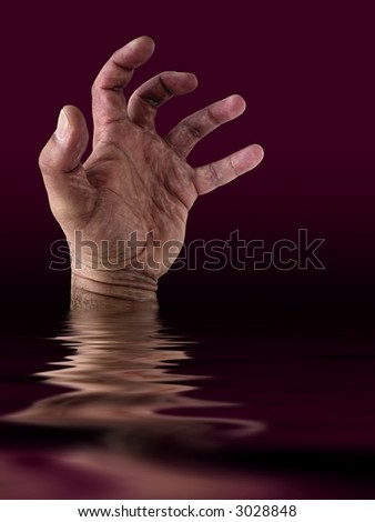 Drowning man\'s hand  in the ocean.