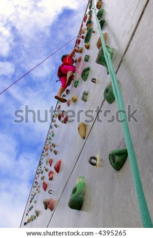 Youngster's effort in climbing a wall to reach the top.