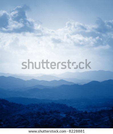 Vertical landscape with mountain formation in the distance.