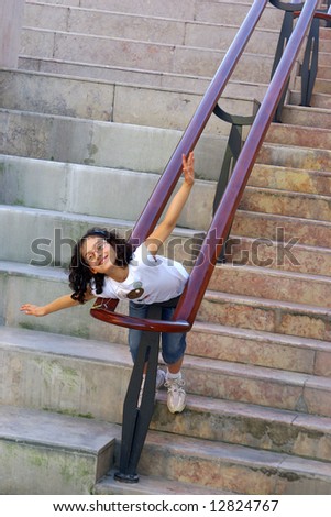 Young girl outdoors posing in a concrete stairway