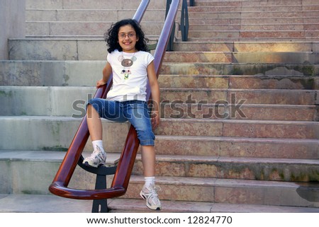 Young girl outdoors posing in a concrete stairway