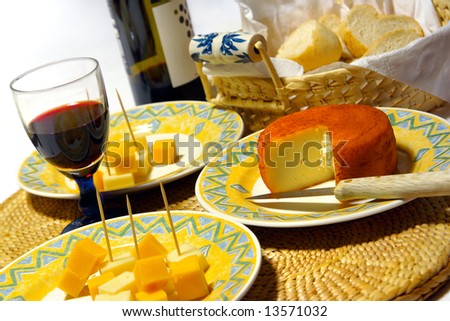 Glass of red wine and assorted cheeses for wine tasting