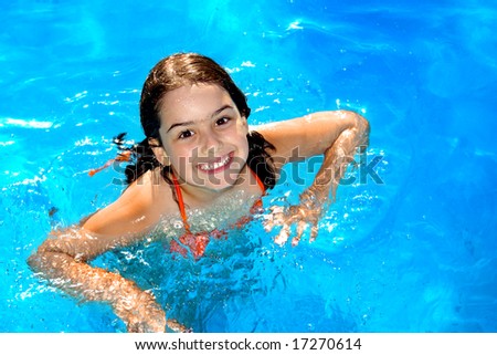 stock photo Happy young girl having fun in the swimmingpool