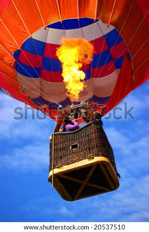 Colorful hot air balloon with bright burning flame