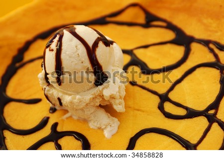 Delicious caramel ice cream over a crepe with chocolate topping