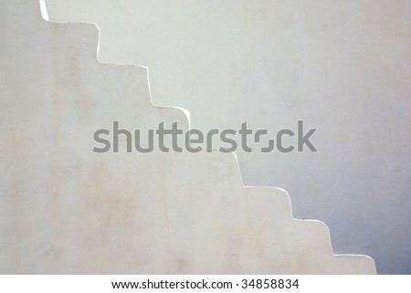 Detail of an old stairway painted in white with highlighted profile
