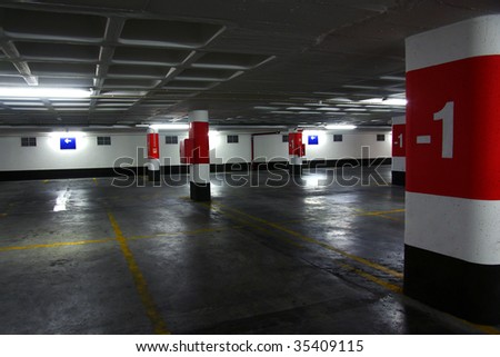 Empty underground parking lot with big concrete columns