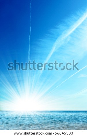 Clean ocean and bright blue sky with sun shining