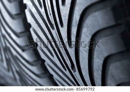 Detail of a row of new racing motor-sport tires is a garage