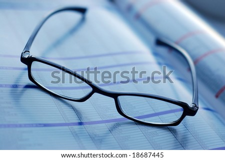 glasses on newspaper page