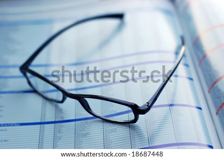 glasses on newspaper page
