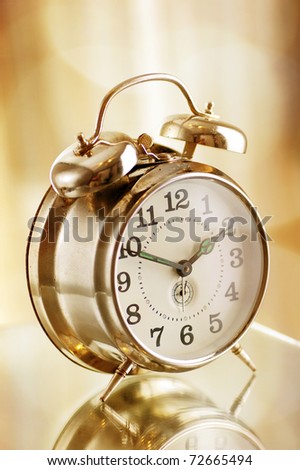 Old fashion alarm clock in warm morning light