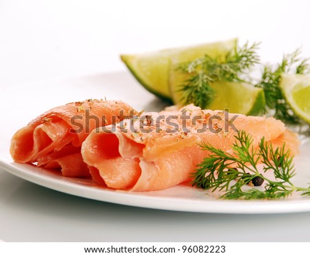 smoked salmon on white plate with herbs and lime