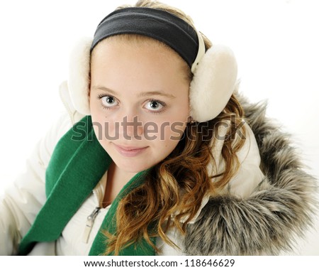 Closeup and overhead view of a pretty young tween dressed for winter.  On a white background.