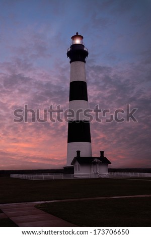 The Bodie Island Light House in NC taken before a cloudy pink and blue sunset..