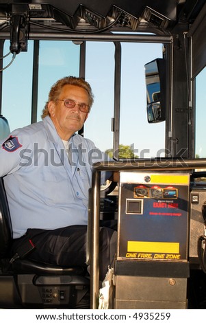 City bus driver at the wheel.