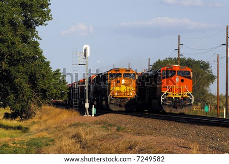 One train passing another on flat land.