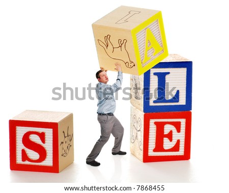 business man creating a sale sign out of giant alphabet business man creating a sale sign out of giant alphabet