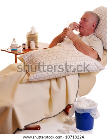 Reclined senior man taking medication for his cold or flu.
