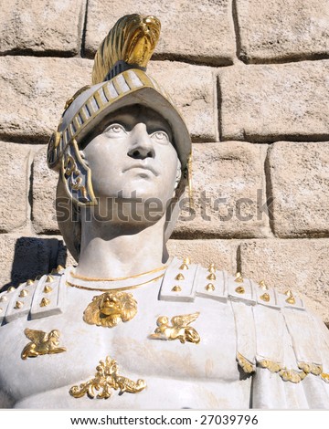 Head and shoulders image of a white statue of a young Roman soldier.