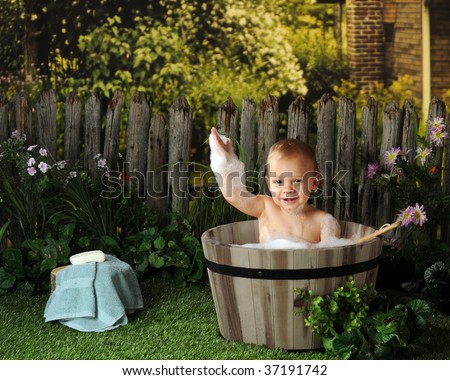 A year-old baby taking an old fashioned bubble bath.