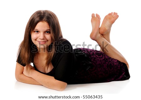 stock photo A lovely young teen dressed up but barefoot reclining on the 