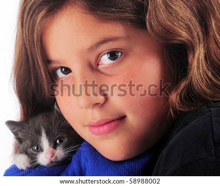 stock photo Closeup portrait of a preteen girl snuggling with her tiny