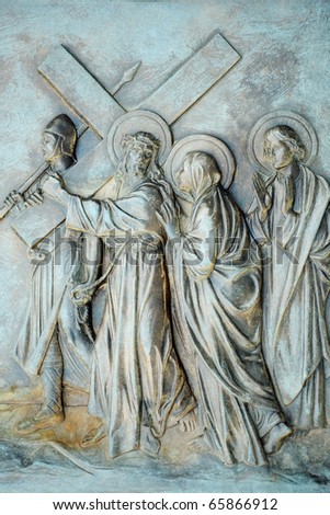 A stone relief depicting the 4th Station of the Cross where the condemned Jesus meets His mother as he carries the cross towards Calvary.