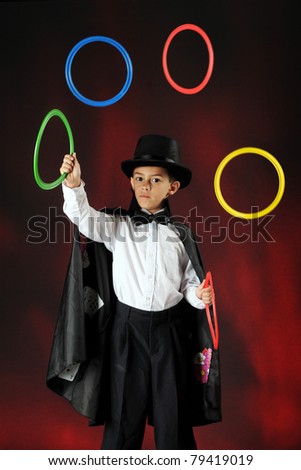 A young magician juggling colorful rings.  Some motion blur on the rings.