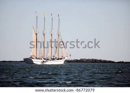 A large boat filled with passengers sailing alone on the ocean.