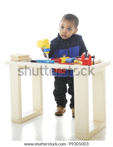  with toy tools on a child-sized workbench. On a white background