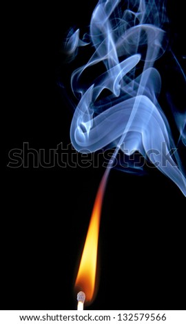 The fire and smoke from the burning and extinguished matches, photo on black background.
