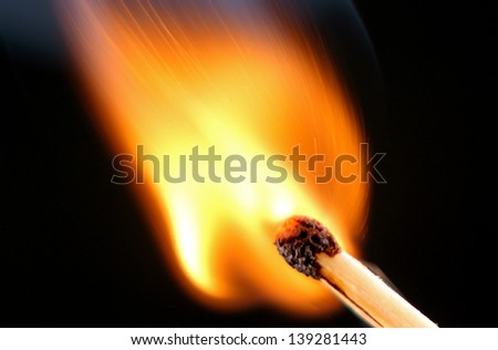 burning matches, fire and curls of smoke, a photo close up on a black background.