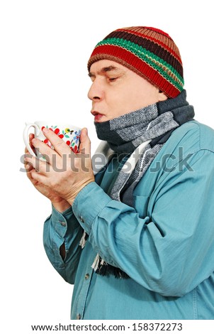 a grown man wearing a scarf and hat with a cup of tea in hand, white background.
