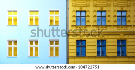 Two facade of different buildings with yellow and blue colors inverted