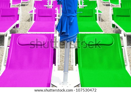 Many colorful dock chairs at the beach
